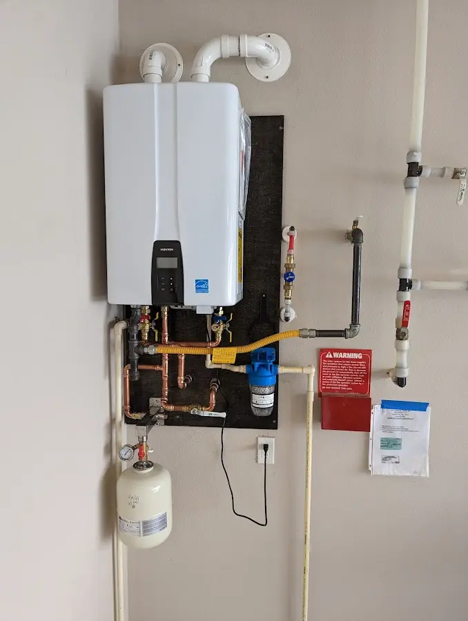 Professional plumber installing copper piping in a Sherrelwood home